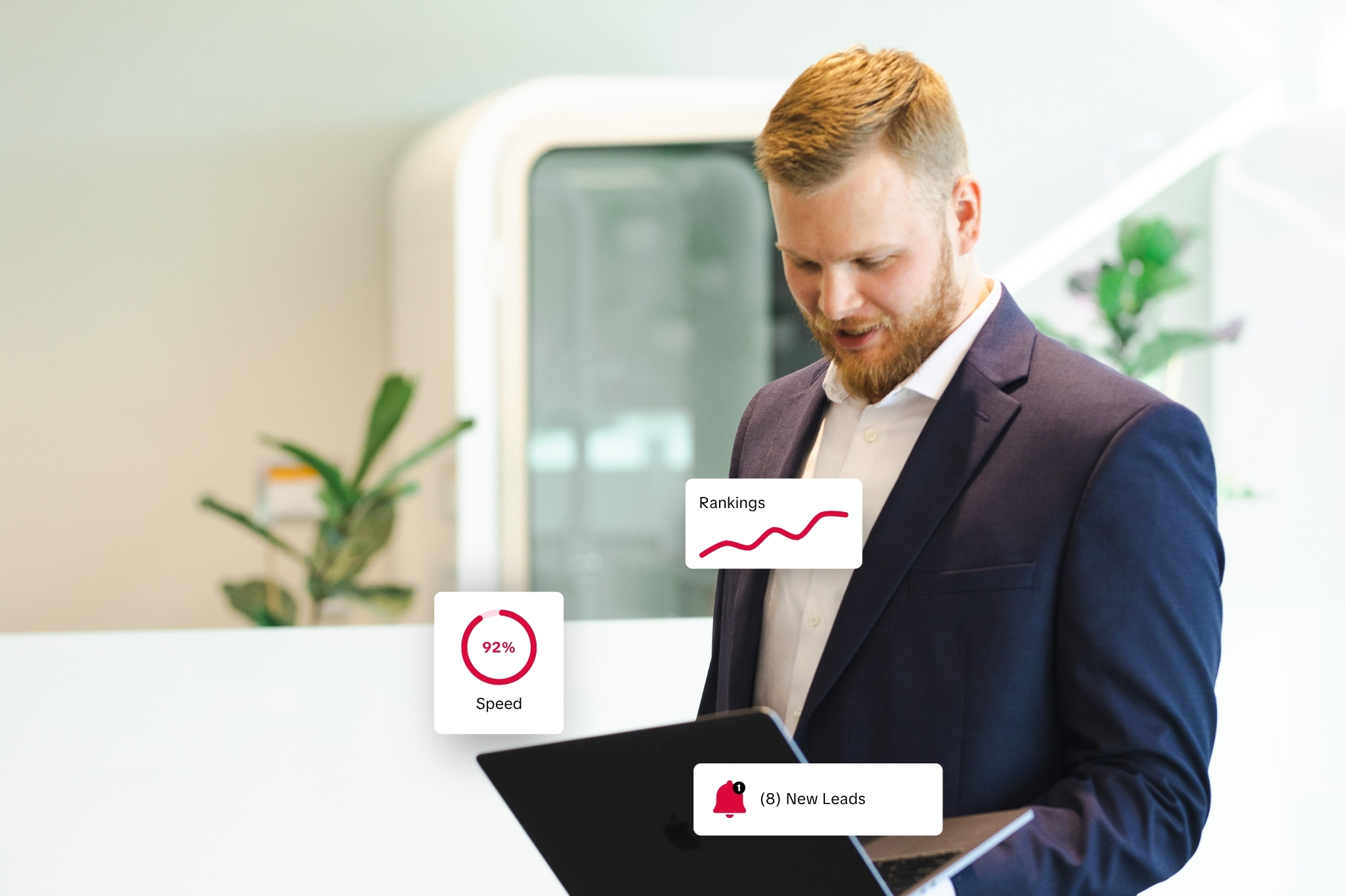 Owner of an Omaha website design agency reviewing website SEO reports on a laptop in a modern office.